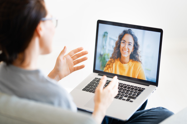 Woman is using laptop for remote conversation